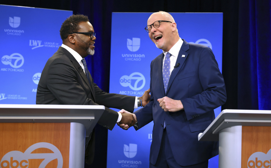 Chicago mayoral candidates Brandon Johnson, left, and Paul Vallas shake hands before the start of a debate at ABC7 studios in downtown Chicago, Thursday, March 16, 2023.