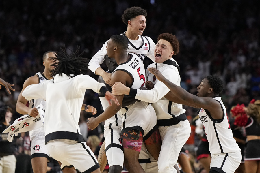 San Diego State guard Lamont Butler (5) celebrates with teammates after scoring the winning basket against Florida Atlantic during a Final Four college basketball game in the NCAA Tournament on Saturday, April 1, 2023, in Houston.