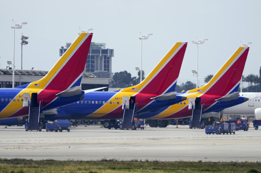 Southwest Airlines planes sit at the terminal at Long Beach Airport Tuesday  in Long Beach, Calif. Southwest planes were grounded nationwide for what the airline called a technology issue.