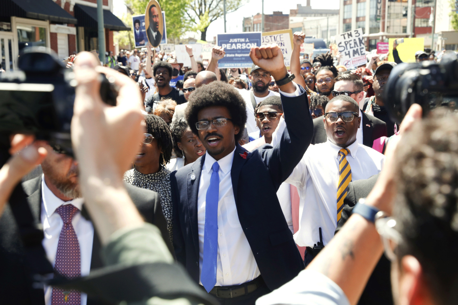 Justin Pearson and his supporters march to the Shelby County Board of Commissioners meeting in Memphis, Tenn., on Wednesday, April 12, 2023, where he will be reinstated to his position in the Tennessee House of Representatives.
