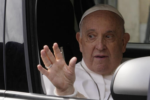 Pope Francis waves from his car as he arrives at The Vatican, Saturday, April 1, 2023, after receiving treatment at the Agostino Gemelli University Hospital for bronchitis, The Vatican said. Francis was hospitalized on Wednesday after his public general audience in St. Peter's Square at The Vatican.