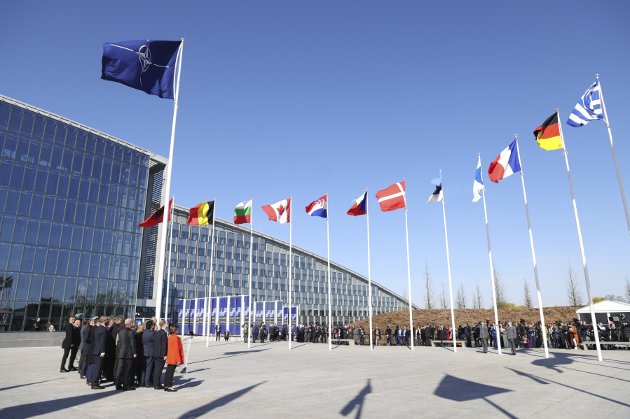 NATO foreign ministers pose in front of flags of NATO members after a flag raising ceremony for Finland on the sidelines of a NATO foreign ministers meeting at NATO headquarters in Brussels, Tuesday, April 4, 2023. Finland joined the NATO military alliance on Tuesday, dealing a major blow to Russia with a historic realignment of the continent triggered by Moscow's invasion of Ukraine.