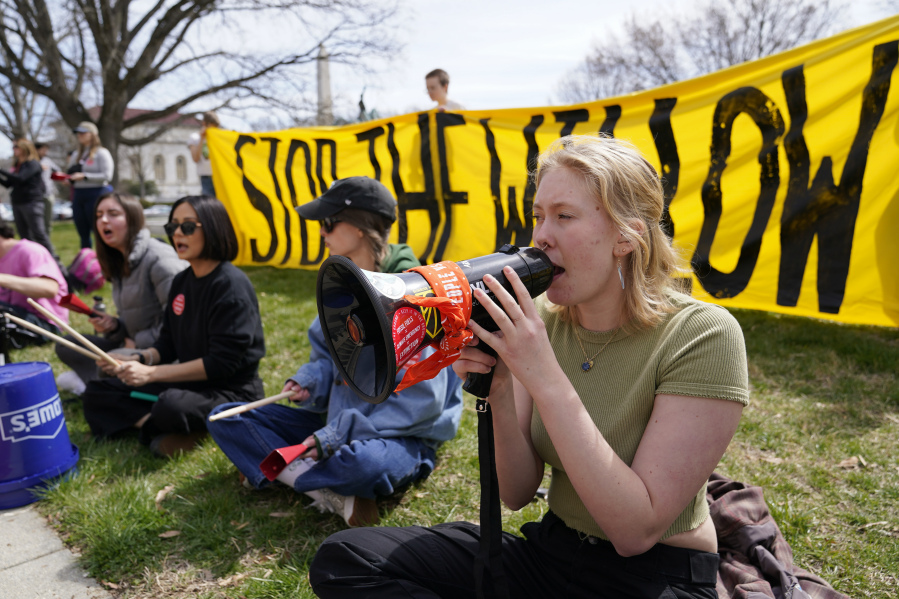 Demonstraters protest against the Biden administration's approval of the Willow oil-drilling project before a scheduled speech by Biden at the Department of the Interior in Washington, Tuesday, March 21, 2023.