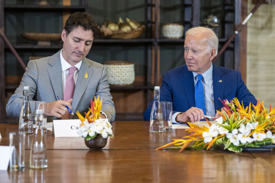 FILE- President Joe Biden looks to Canadian Prime Minister Justin Trudeau during a meeting of G7 and NATO leaders in Bali, Indonesia, Nov. 16, 2022. Biden arrives in Canada on Thursday, March 23, 2023, with a focus on several of the world's largest challenges: the war in Ukraine, climate change, trade, mass migration and an increasingly assertive China. The administration has made strengthening its friendship with Canada a priority over the past two years. Biden's meetings with Trudeau in the capital of Ottawa is an opportunity to set plans for the future.