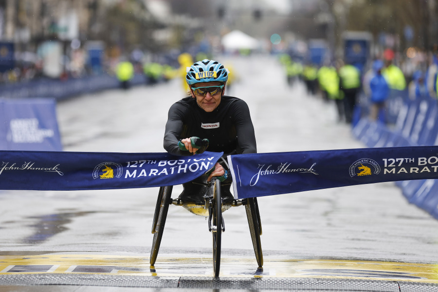 Susannah Scaroni breaks the tape to win the women's wheelchair division of the 127th Boston Marathon Monday, April 17, 2023, in Boston.