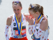 FILE -- Adrianne Haslet, right, cries as Shalane Flanagan, left, comforts her following their finish in the 2022 Boston Marathon, April 18, 2022, in Boston. Haslet is back in the field in 2023 for Monday's 127th Boston Marathon as the city, the country and fans of the cherished sporting event mark 10 years since the finish line attacks. (Matthew J.