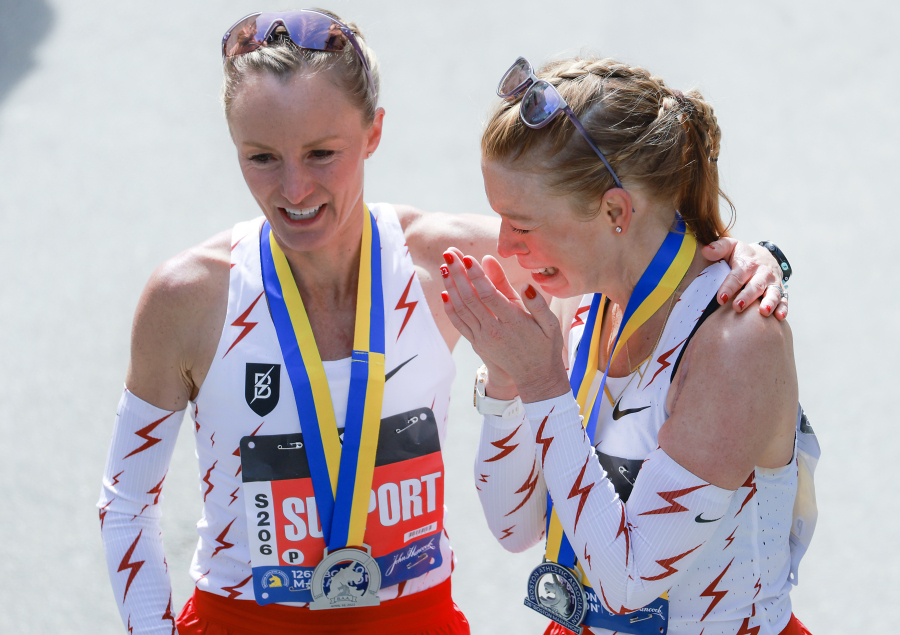 FILE -- Adrianne Haslet, right, cries as Shalane Flanagan, left, comforts her following their finish in the 2022 Boston Marathon, April 18, 2022, in Boston. Haslet is back in the field in 2023 for Monday's 127th Boston Marathon as the city, the country and fans of the cherished sporting event mark 10 years since the finish line attacks. (Matthew J.