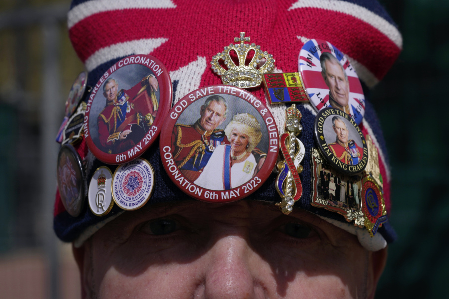 Royal fan John Loughrey stands next to a fence barricade near Buckingham Palace prior to the coronation of Britain's King Charles III, in Central London, Saturday, April 29, 2023.