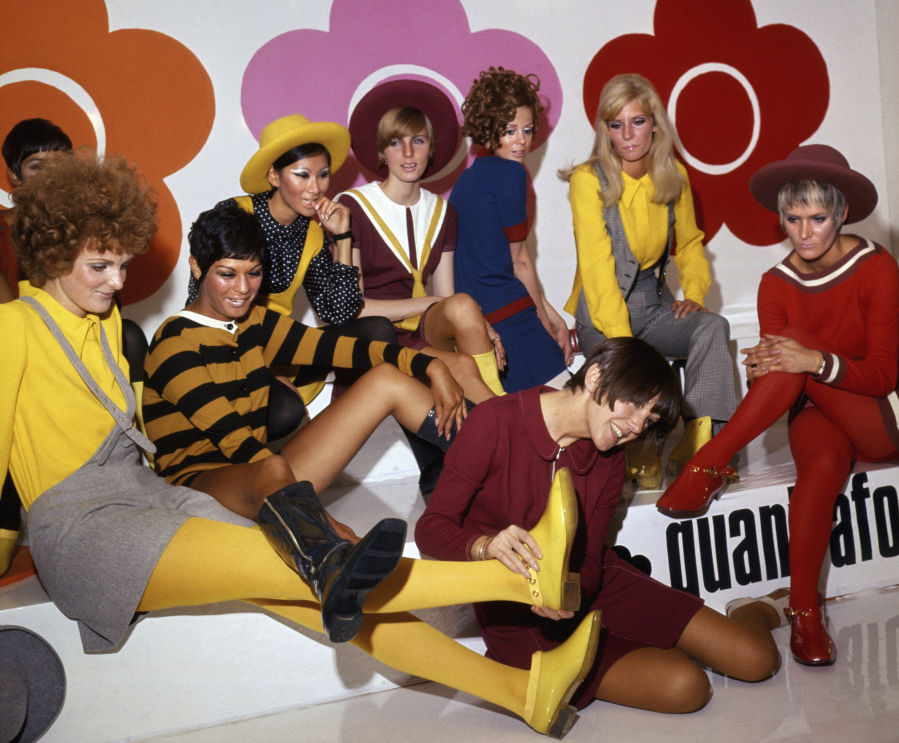 FILE - British fashion designer Mary Quant, foreground center, poses with models wearing her creations, in London, on Aug. 1, 1967. Quant, the designer whose fashions epitomized the Swinging 60s, has died at the age of 93. Quant's family said she died "peacefully at home" in Surrey, southern England, on Thursday, April 13, 2023.