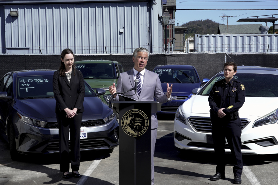 California Attorney General Rob Bonta, center, flanked by Deputy Attorney General Holly Mariella, left, and Berkeley Police Chief Jennifer Louis, right, speaks during a news conference Thursday, April 20, 2023, in Berkeley, Calif., about the surge in thefts of KIA and Hyundai vehicles. Attorneys general in 17 states plus Washington, DC, on Thursday urged the federal government to recall millions of Kia and Hyundai cars because they are too easy to steal; a response to a sharp increase in thefts fueled by a viral social media challenge.