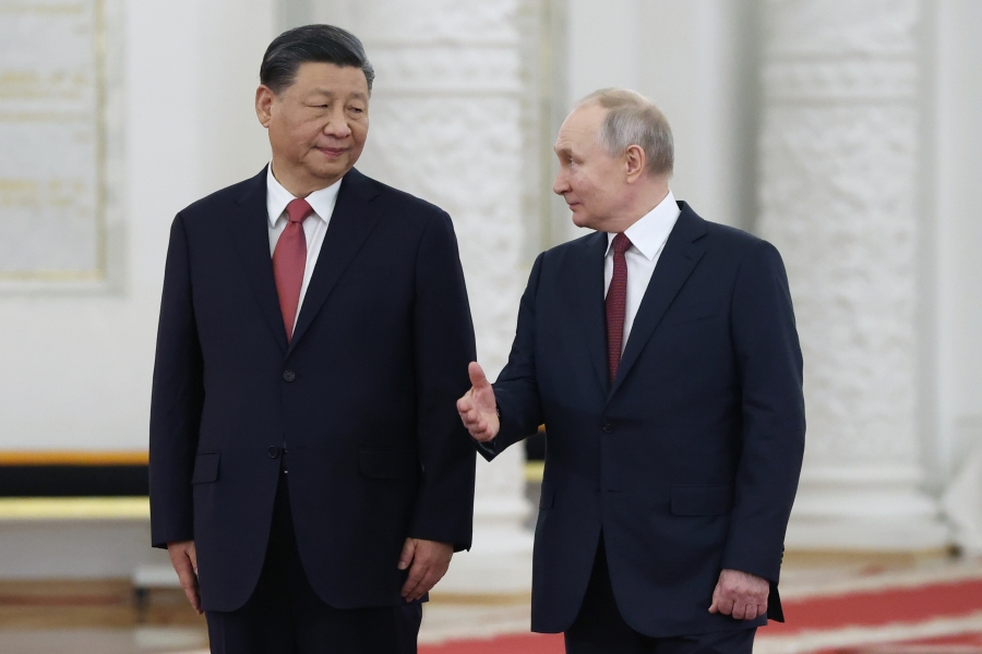 FILE - Russian President Vladimir Putin, right, speaks to Chinese President Xi Jinping as they attend an official welcome ceremony at The Grand Kremlin Palace, in Moscow, Russia, March 21, 2023.