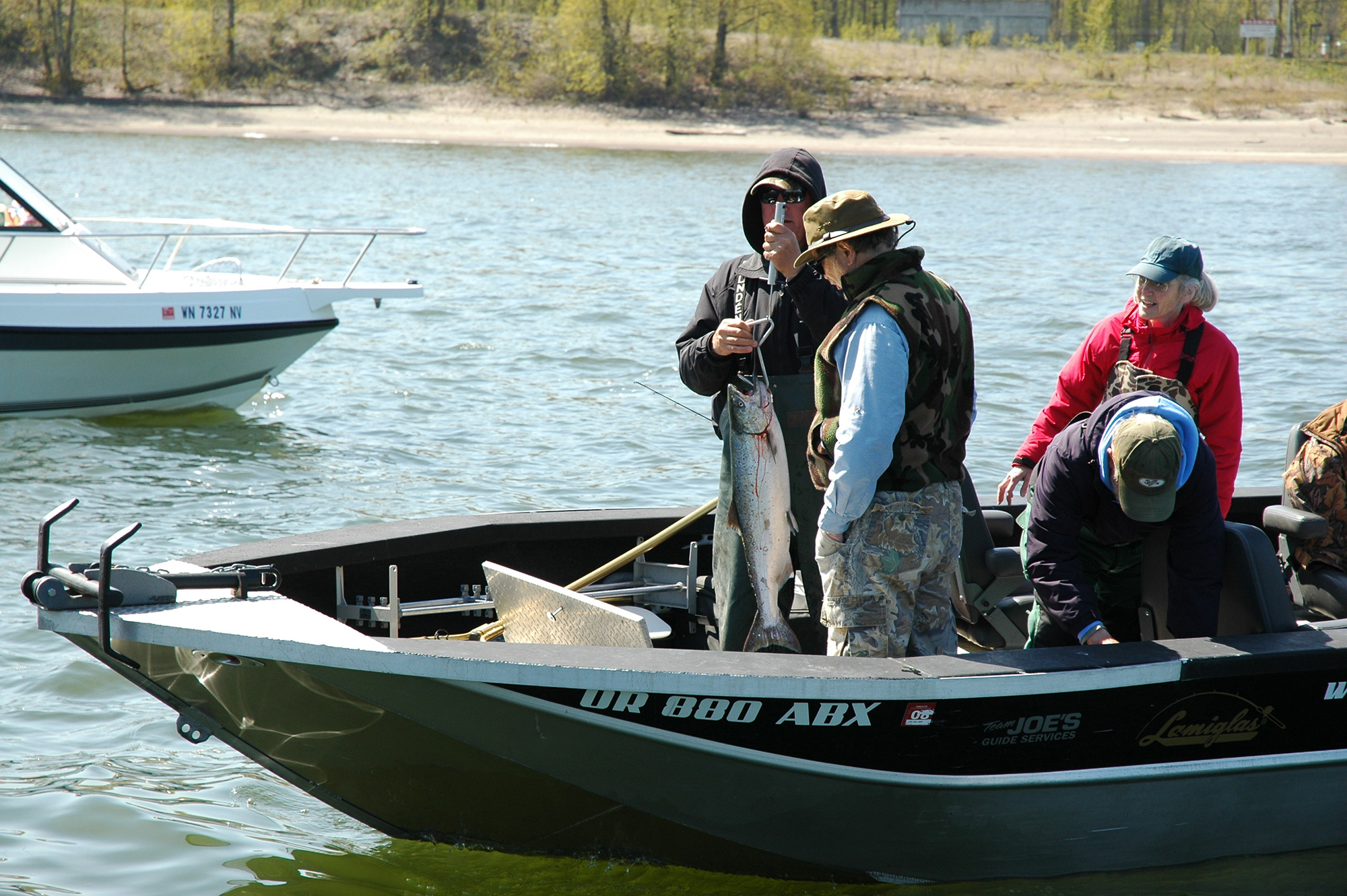 Anglers check their catch of a spring Chinook in the Columbia River off Hayden Island downstream of the BNSF railroad bridge a few years ago. The 2023 season has been extended four days to April 11, it was announced on Tuesday, April 4, 2023.