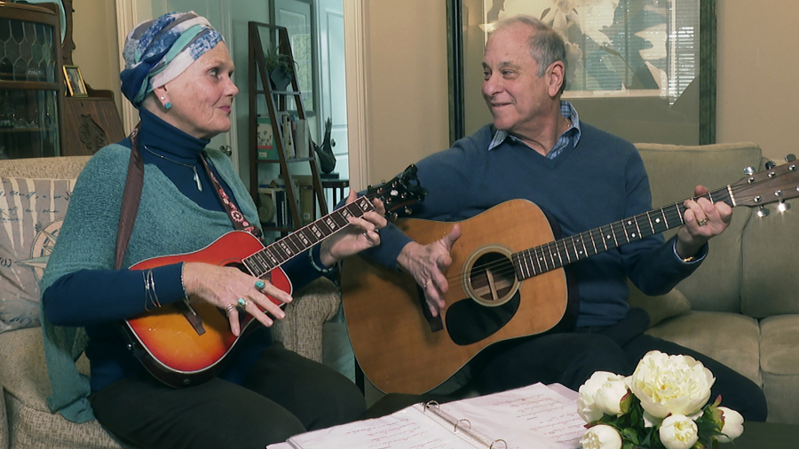 Lynda Shannon Bluestein, left, jams with her husband, Paul, in the living room of their home, Feb. 28, 2023, in Bridgeport, Conn. "Please do not make the end of life harder for me," wrote Bluestein, 75, to the Drug Enforcement Agency. In March, Bluestein, who has terminal fallopian tube cancer, reached a settlement with the state of Vermont that will allow her to be the first non-resident to use its medically assisted suicide law. By the time she's ready to use the drugs, she expects to be too ill to travel to see a doctor in person for the prescription, she wrote.