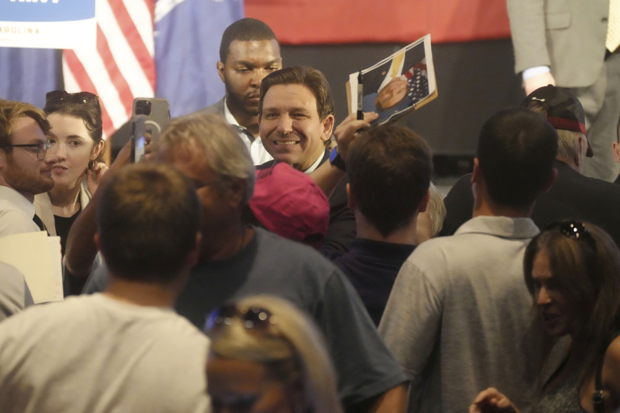 Gov. Ron DeSantis, R-Fla., smiles for photos as he signs books following remarks to a crowd at First Baptist North on Wednesday, April 19, 2023, in Spartanburg, S.C.
