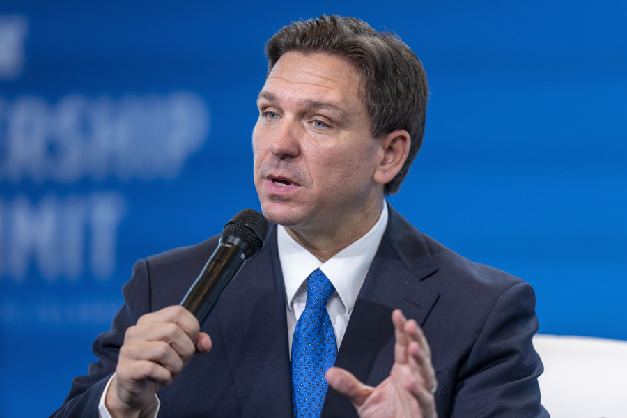 FILE - Florida Gov. Ron DeSantis speaks at the Heritage Foundation 50th Anniversary Celebration leadership summit, Friday, April 21, 2023, in Oxon Hill, Md. Former Nevada Attorney General Adam Laxalt will help lead a political action committee that is encouraging DeSantis to run for president.