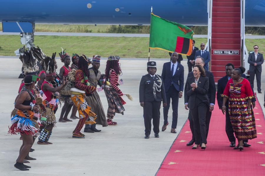 FILE - Vice President Kamala Harris, second right, is greeted by traditional dancers after landing in Lusaka, Zambia, Friday, March 31, 2023. Harris is poised to play a critical role in next year's election as President Joe Biden seeks a second term.
