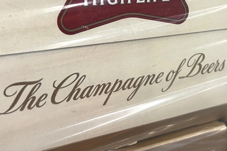 In this image provided by Comite Champagne, a label on the side of a carton of Miller High Life beer at the Westlandia plant in Ypres, Belgium, Monday, April 17, 2023. Belgian customs have destroyed more than 2,000 cans of Miller High Life advertised as the ?Champagne of beers" at the request of houses and growers of the bubbly beverage.