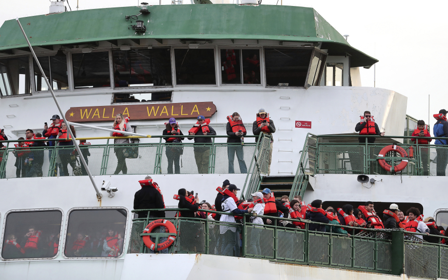 Passengers aboard the Walla Walla passenger ferry gather on the bow after the vessel ran aground near Bainbridge Island west of Seattle on Saturday, April 15, 2023. (Meegan M.