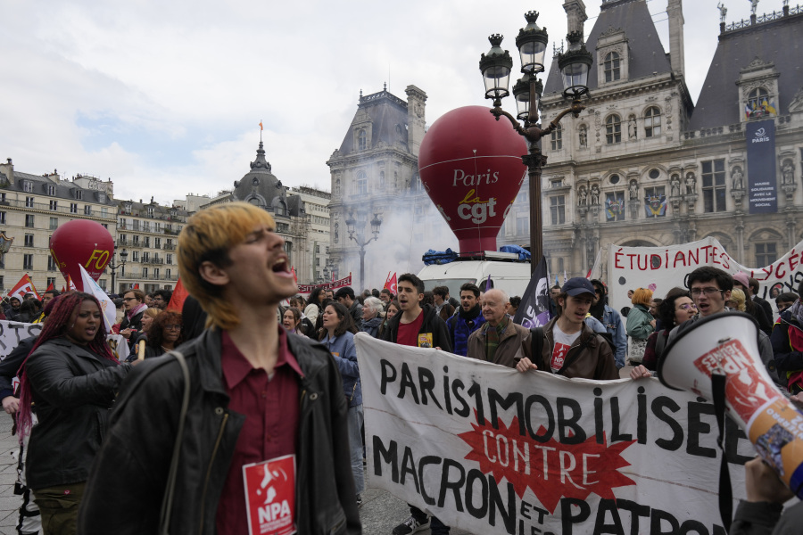 Demonstrators stage a protest against the pension reforms outside the City Hall in Paris, Thursday, April 20, 2023. Union activists stage scattered actions to press France's government to scrap the new law raising the retirement age.