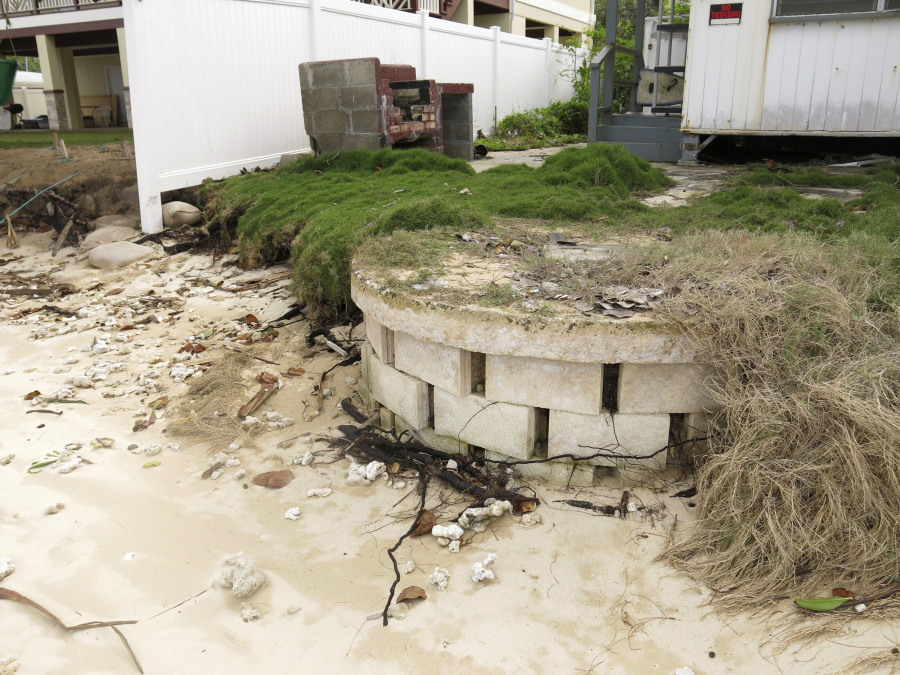 FILE -- This Jan. 26, 2015 photo provided by the Hawaii Department of Land and Natural Resources shows a partially exposed cinderblock cesspool pit with a lid on a badly eroding shoreline in Punaluu, Hawaii.A former Hawaii lawmaker is expected in court for sentencing in a federal corruption case that's drawn attention to a perennial problem in the islands: the tens of thousands of cesspools that release 50 million gallons of raw sewage into the state's pristine waters every day.