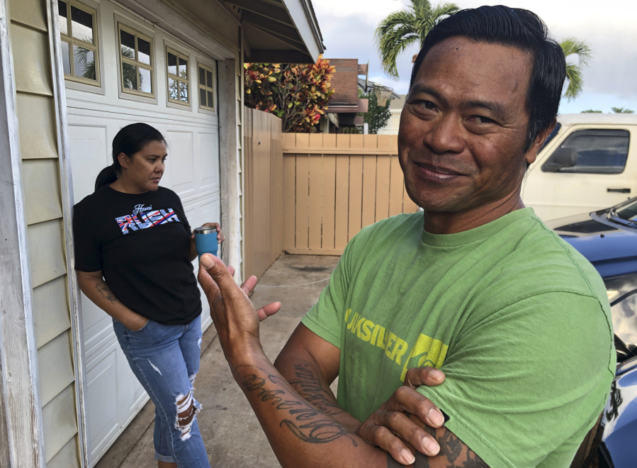 Tedorian Gallano, right, and his wife Nicole Gallano, stand outside their home in Waianae, Hawaii, on Feb. 26, 2023. Hawaii's housing shortage has set off a population decline and grown so acute it has sparked widespread concern many of Hawaii's children won't be able to afford living in their homeland as adults.