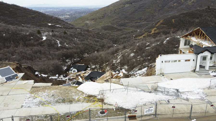 The debris of two homes in Draper, Utah that have reportedly been evacuated for months sits at the bottom of a hill after sliding overnight on Saturday, April 22, 2023.