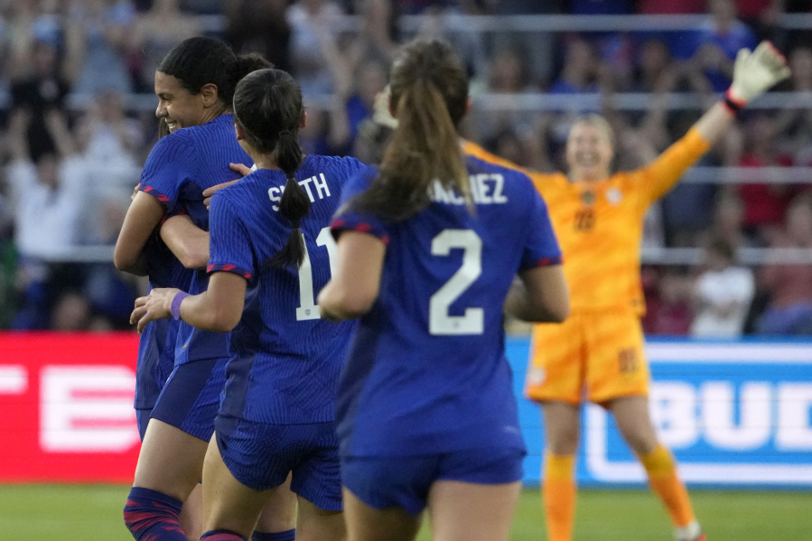 United States' Alana Cook, left, is congratulated by teammates after scoring during the first half of an international friendly soccer match against Ireland Tuesday, April 11, 2023, in St. Louis.