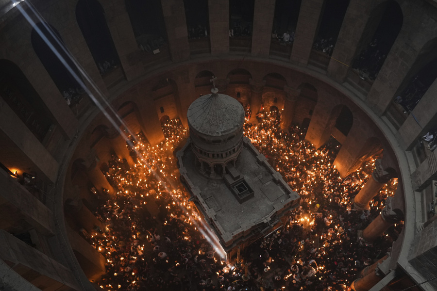 Christian pilgrims hold candles during the Holy Fire ceremony, a day before Easter, at the Church of the Holy Sepulcher, where many Christians believe Jesus was crucified, buried and resurrected, in Jerusalem's Old City, Saturday, April 15, 2023.