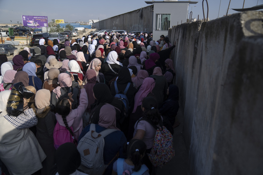 Palestinian women gather behind closed gates while they try to cross from the occupied West Bank into Jerusalem, to pray during the holiest night of Ramadan, Laylat al-Qadr, or the "Night of Destiny," when Muslims believe that the Quran was revealed to the Prophet Mohammad, in the Al Aqsa mosque compound, at the Israeli military Qalandiya checkpoint, near Ramallah, Monday, April 17, 2023. Hundreds of thousands of Palestinians are barred from legally crossing into the contested capital, with most men under 55 years old turned away at checkpoints, and compelled to resort to other, perilous means to get to Al-Aqsa.