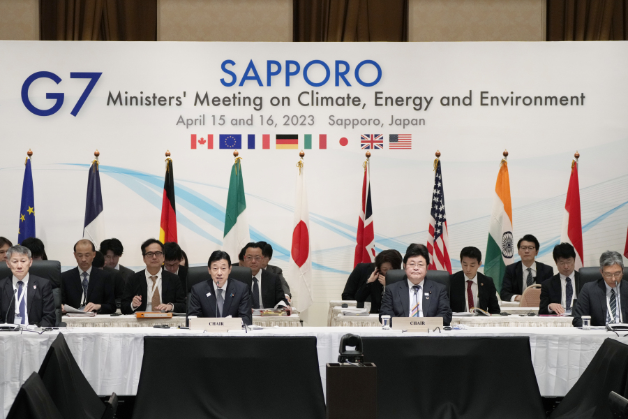 Japan's Economy Minister Yasutoshi Nishimura, center left, with Environment Minister Akihiro Nishimura, center right, speaks at the beginning of a plenary session in the G-7 ministers' meeting on climate, energy and environment as they co-chair the meeting in Sapporo, northern Japan, Saturday, April 15, 2023.