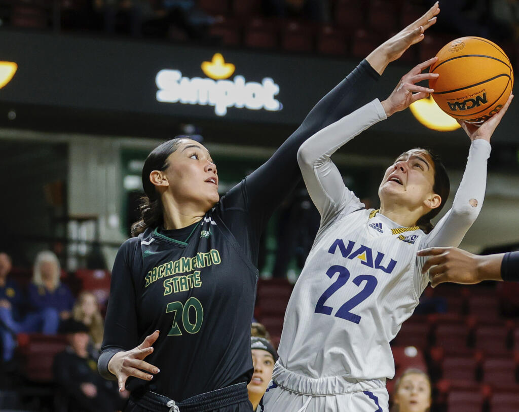 Sacramento State guard Katie Peneueta (20) defends against Northern Arizona guard Olivia Moran (22) in the first half of an NCAA college basketball game for the championship of the Big Sky women's tournament in Boise, Idaho, Wednesday, March 8, 2023, in Boise, Idaho.
