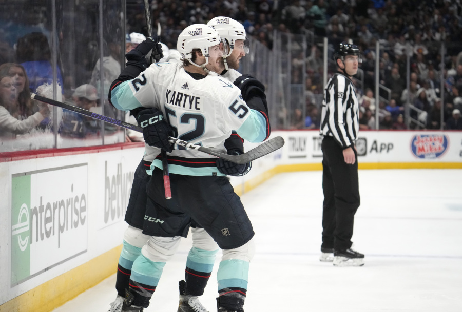 Seattle Kraken forward Tye Kartye, front, celebrates his goal against the Colorado Avalanche with defenseman Will Borgen during the second period of Game 5 of an NHL hockey first-round playoff series Wednesday, April 26, 2023, in Denver.
