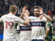 Vancouver Whitecaps' Brian White, right, celebrates with Julian Gressel after scoring a goal against the Portland Timbers during the second half of an MLS soccer match Saturday, April 8, 2023, in Vancouver, British Columbia.