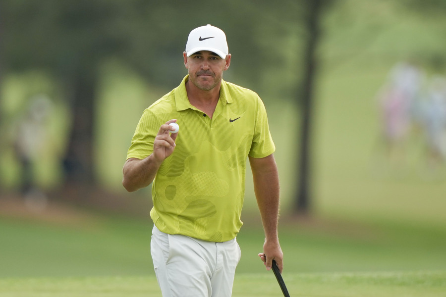 Brooks Koepka waves after his putt on the 18th hole during the first round of the Masters golf tournament at Augusta National Golf Club on Thursday, April 6, 2023, in Augusta, Ga.