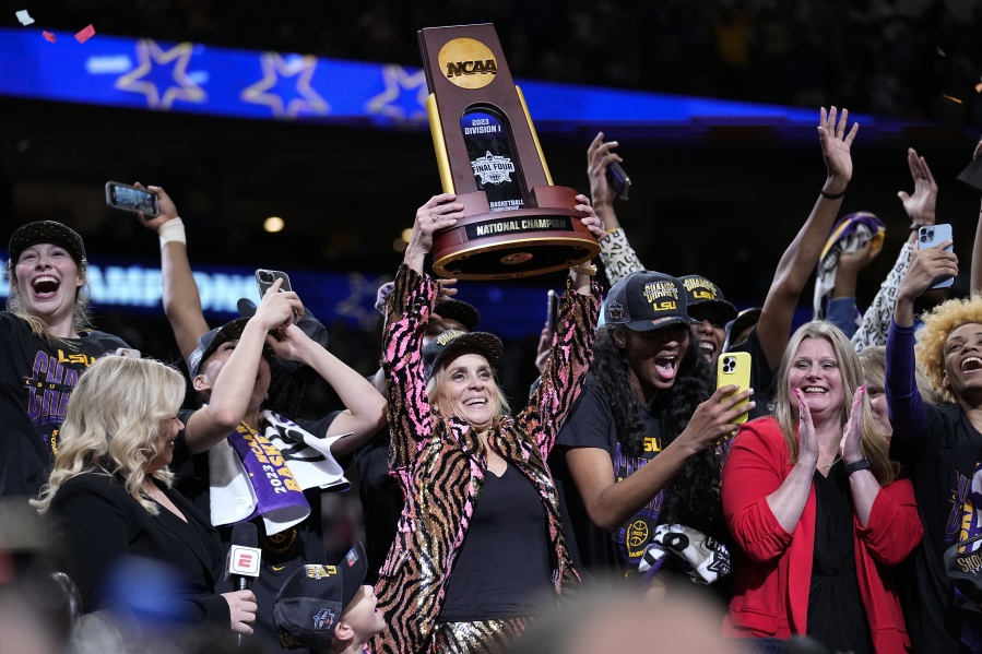 LSU head coach Kim Mulkey holds the winning trophy after the NCAA Women's Final Four championship basketball game against Iowa Sunday, April 2, 2023, in Dallas. LSU won 102-85 to win the championship.