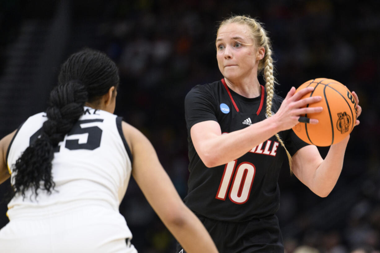 Louisville guard Hailey Van Lith (10) looks for a pass as Iowa forward Hannah Stuelke defends in the second half of an Elite 8 college basketball game of the NCAA Tournament, Sunday, March 26, 2023, in Seattle.