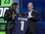 Illinois defensive back Devon Witherspoon, left, stands with NFL Commissioner Roger Goodell after being chosen by the Seattle Seahawks with the fifth overall pick during the first round of the NFL football draft, Thursday, April 27, 2023, in Kansas City, Mo.