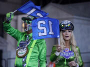 Seattle Seahawks fans cheer on the third day of the NFL football draft, Saturday in Kansas City, Mo.