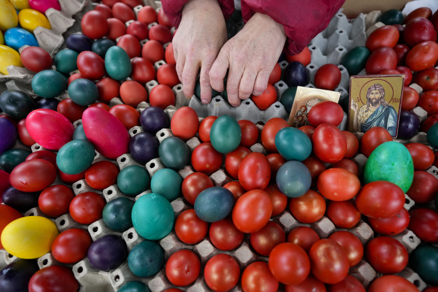 A vendor arranges hand-decorated Easter eggs, on Orthodox Good Friday at a green market, in Belgrade, Serbia, Friday, April 14, 2023. Orthodox Serbs celebrate Easter on April 16, according to the old Julian calendar.