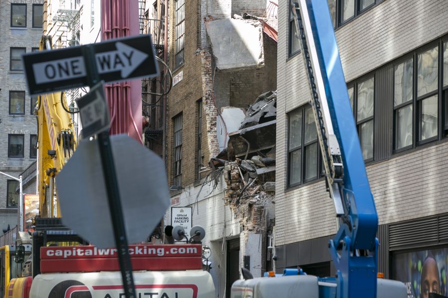 Demolition workers tear down what remains of a partially collapsed parking garage in New York City on Wednesday, April 19, 2023.