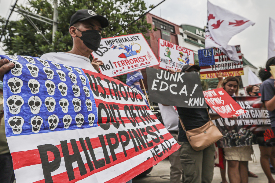 Demonstrators carry placards and shout slogans during a rally in front of Camp Aguinaldo military headquarters in Quezon City, Philippines on Tuesday, April 11, 2023 as they protest against opening ceremonies for the joint military exercise flag called "Balikatan," Tagalog for shoulder-to-shoulder. The United States and the Philippines on Tuesday launch their largest combat exercises in decades that will involve live-fire drills, including a boat-sinking rocket assault in waters across the South China Sea and the Taiwan Strait that will likely inflame China.