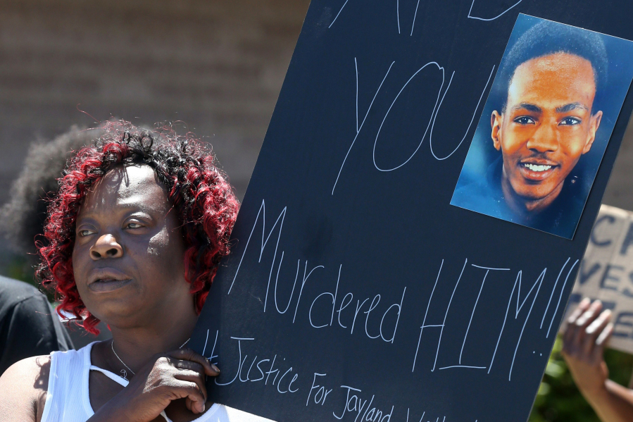 FILE - Lynnette Williams holds a sign during a gathering at Second Baptist Church in Akron, Ohio, calling for justice for Jayland Walker, July 2, 2022. A grand jury in Ohio will hear evidence this week to decide whether police officers should face criminal charges in the shooting of Jayland Walker, a 25-year-old Black man whose death sparked protests in Akron last summer.