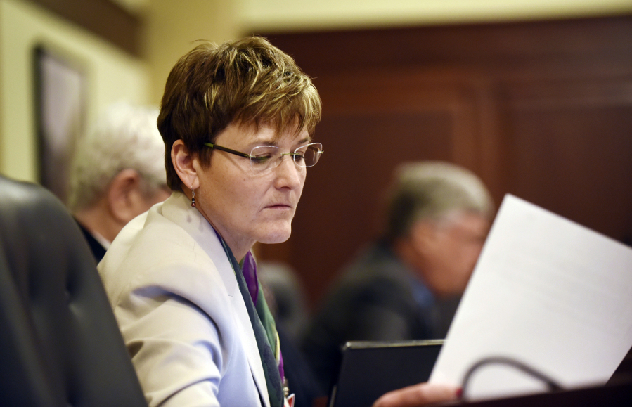 FILE - Democratic Rep. Melissa Wintrow, of Boise, looks at a paper before presenting legislation at the House Judiciary, Rules and Administration Committee meeting in the House Hearing Room in the Idaho Statehouse, Feb. 15, 2016. On Monday, March 27, 2023, the Idaho Senate voted 22-12 to pass a bill criminalizing gender-affirming healthcare for minors, one month after the state House passed similar legislation. Before the vote, Wintrow read a letter from a constituent pleading with lawmakers to reject the bill.