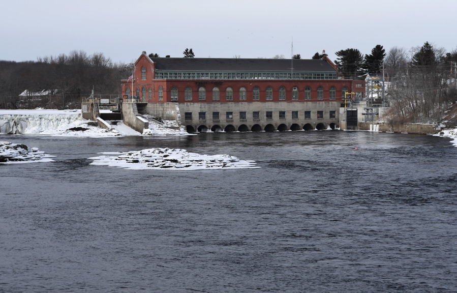 FILE- In this Jan. 19, 2019 file photo, the Brookfield Renewable hydroelectric facility stands at the Milford Dam on the Penobscot River in Milford, Maine. Environmental groups have withdrawn a lawsuit against  Brookfield about their contention the dam owner illegally kills the final remaining wild Atlantic salmon in the U.S. (AP Photo/Robert F.