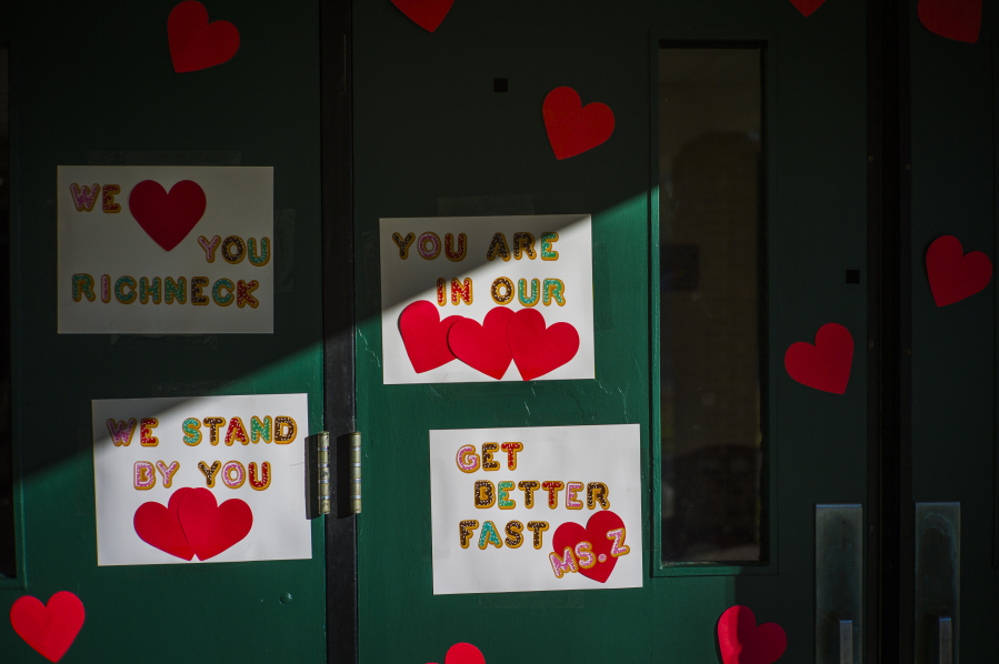 FILE - Messages of support for teacher Abby Zwerner, who was shot by a 6-year-old student, grace the front door of Richneck Elementary School Newport News, Va. on Jan. 9, 2023.  Zwerner said Monday, March 20, that she has had four surgeries and has gone through a challenging recovery. (AP Photo/John C.