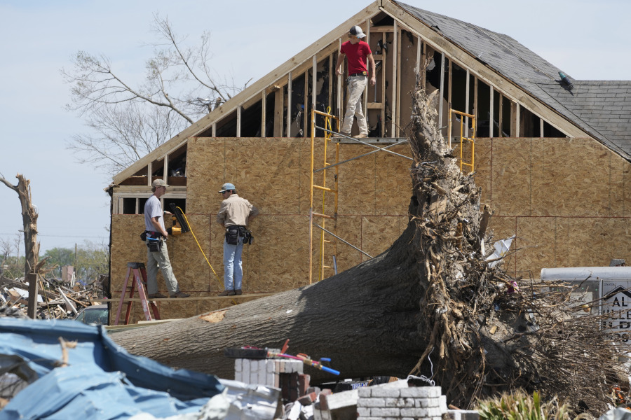 Work crews rebuild the walls to this Rolling Fork, Miss., home following the March 24 killer tornado destroyed much of the small town and also hit a number of Mississippi communities, on March 29, 2023. Many communities are in the midst of cleanup. (AP Photo/Rogelio V.