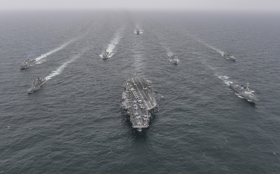 In this photo provided by the South Korea Defense Ministry, South Korean Navy's destroyer Yulgok Yi I, front row right, U.S. Navy's aircraft carrier USS Nimitz, center, Japan Maritime Self-Defense Force's Umigiri, front row left, sail in formation during a joint naval exercise in international waters off South Korea's southern island of Jeju, Tuesday, April 4, 2023. The South Korean, U.S. and Japanese navies began their first anti-submarine drills in six months on Monday to boost their coordination against increasing North Korean missile threats, South Korea's military said.