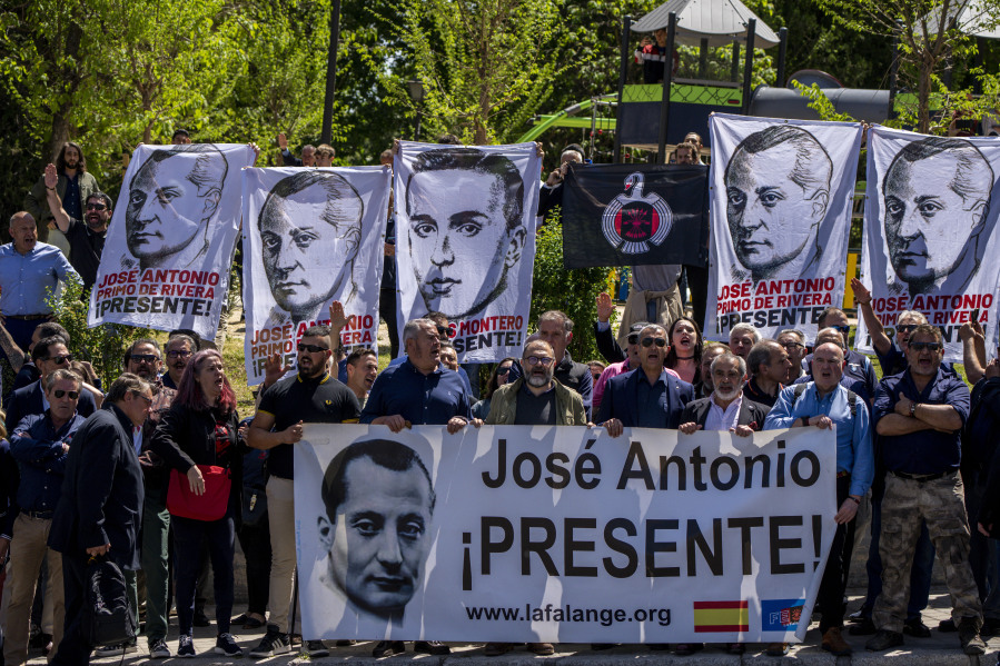 Dozens of people gather outside the San Isidro Cemetery in Madrid, Spain, Monday, April 24, 2023. The body of Jose Antonio Primo de Rivera, the founder of Spain's fascist Falange movement, is exhumed from a Madrid mausoleum and transferred to a city cemetery.