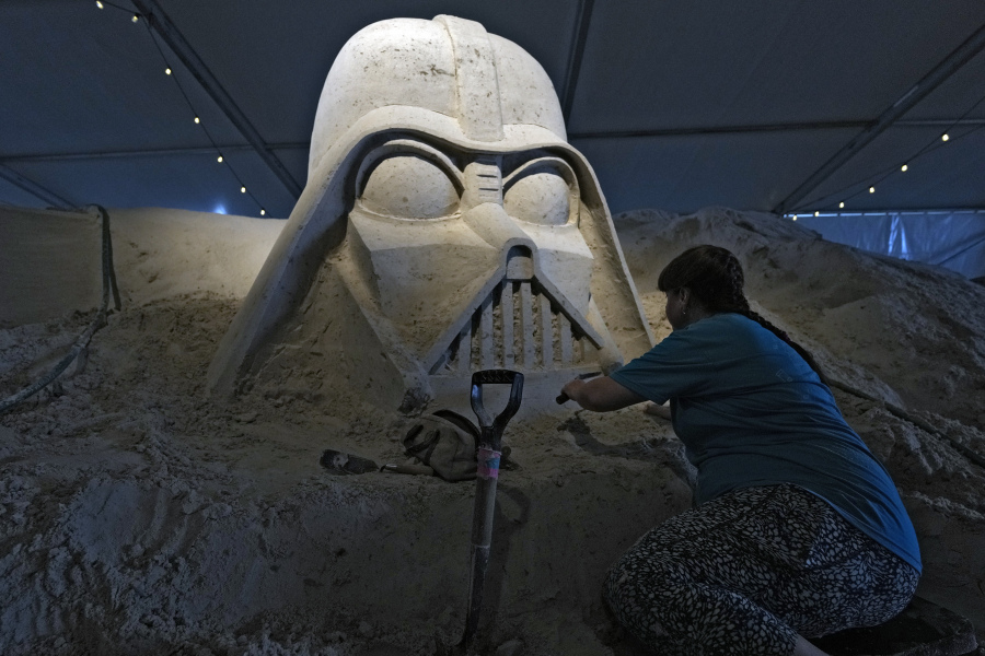 Karen Fralich, of Toronto, Canada works on her Darth Vader, from the "Star Wars" movies, sand sculpture during preparations for the 2023 Sugar Sand Festival Monday, April 3, 2023, in Clearwater Beach, Fla. The festival runs from April 7th thru April 23rd.