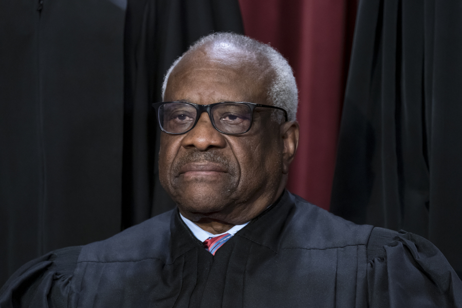 FILE - Associate Justice Clarence Thomas joins other members of the Supreme Court as they pose for a new group portrait, at the Supreme Court building in Washington, Oct. 7, 2022. Thomas has for more than two decades accepted luxury trips nearly every year from Republican megadonor Harlan Crow without reporting them on financial disclosure forms, ProPublica reports. (AP Photo/J.